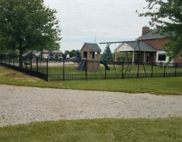 Pool Surround with Rings and Puppy Panel in Liberty Township aluminum fencing