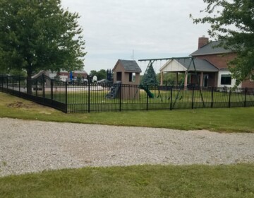 Pool Surround with Rings and Puppy Panel in Liberty Township aluminum fencing